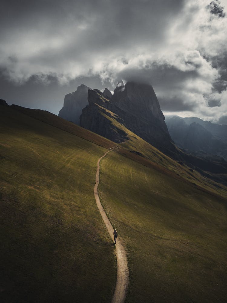 Backpacker Hiking On A Lonely Trail In The Mountains 