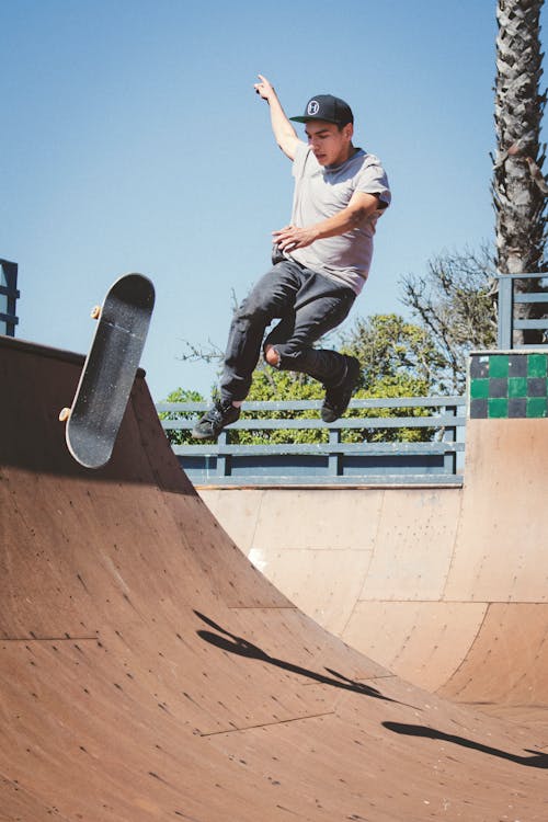 Free Man Performing Skateboard Tricks Stock Photo