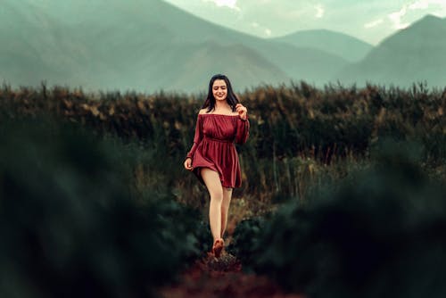 Brunette Woman in Dress Walking Barefoot on Meadow