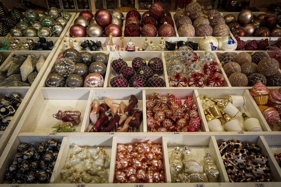 A festive assortment of Christmas ornaments arranged in a store display, offering a variety of colors and styles.