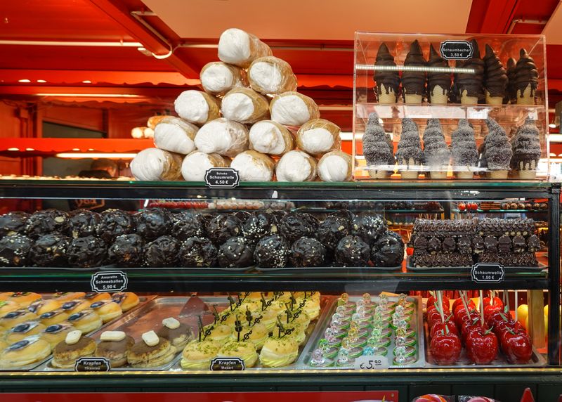 Delicious assortment of pastries and sweets on display in a vibrant bakery. Perfect temptation for dessert lovers.