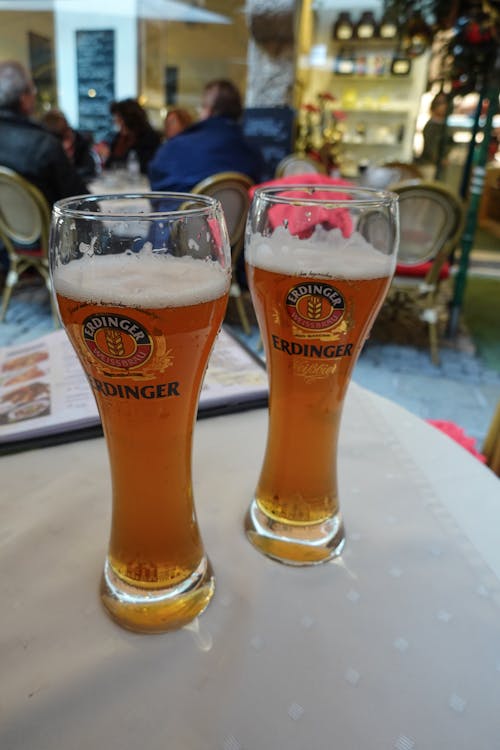 Two Glasses of Beer on a Table in a Patio 