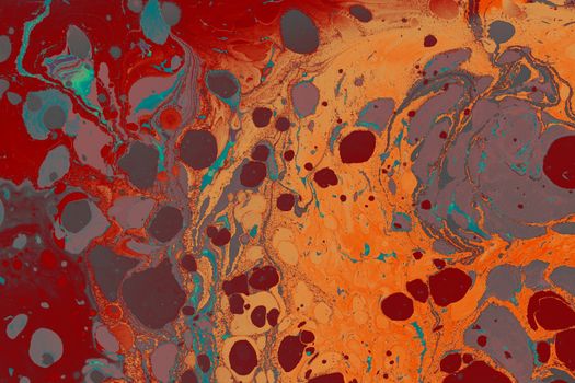 Vibrant abstract marbled texture with swirling paint in red and orange tones.