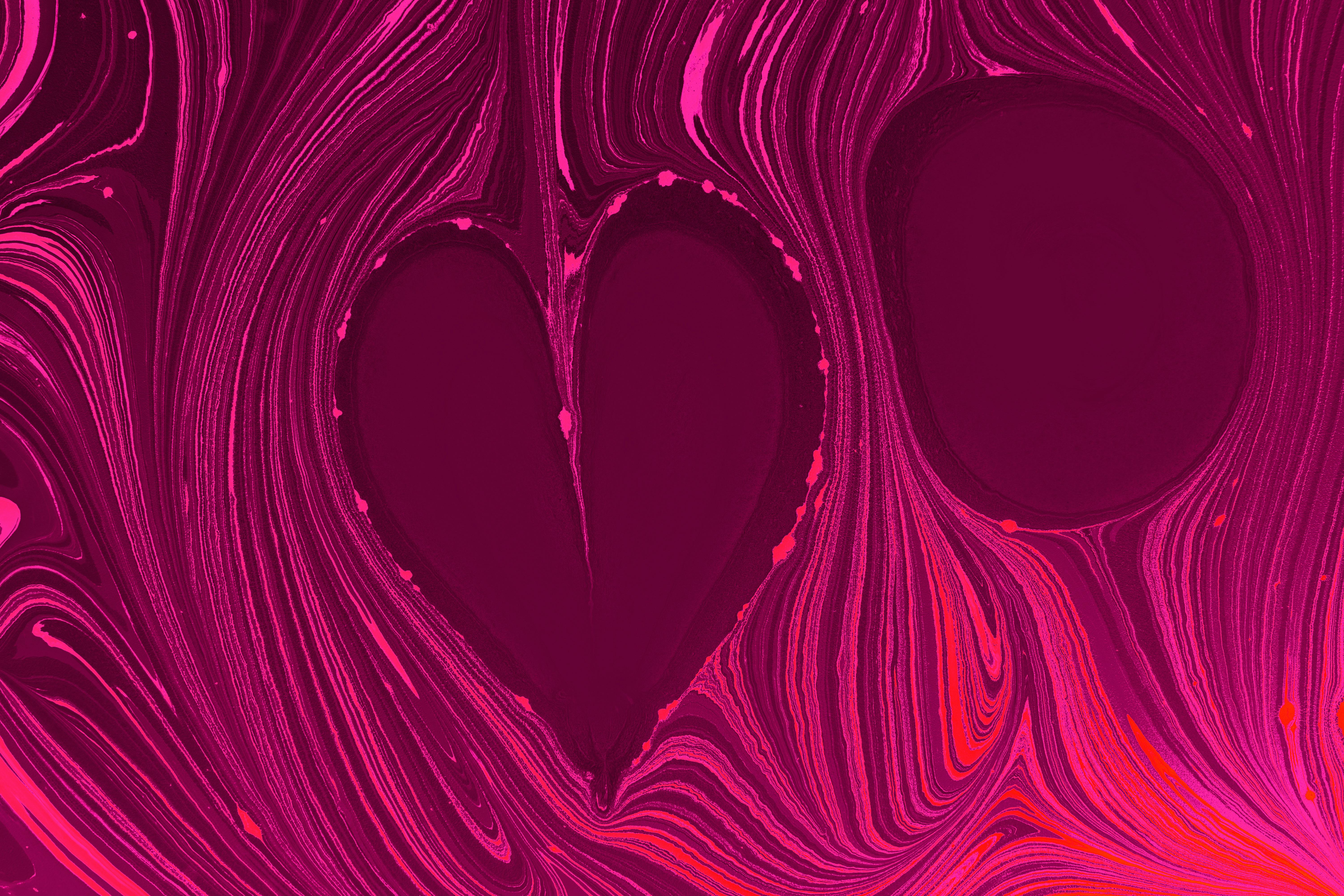 a pink and purple heart shaped design on a purple background