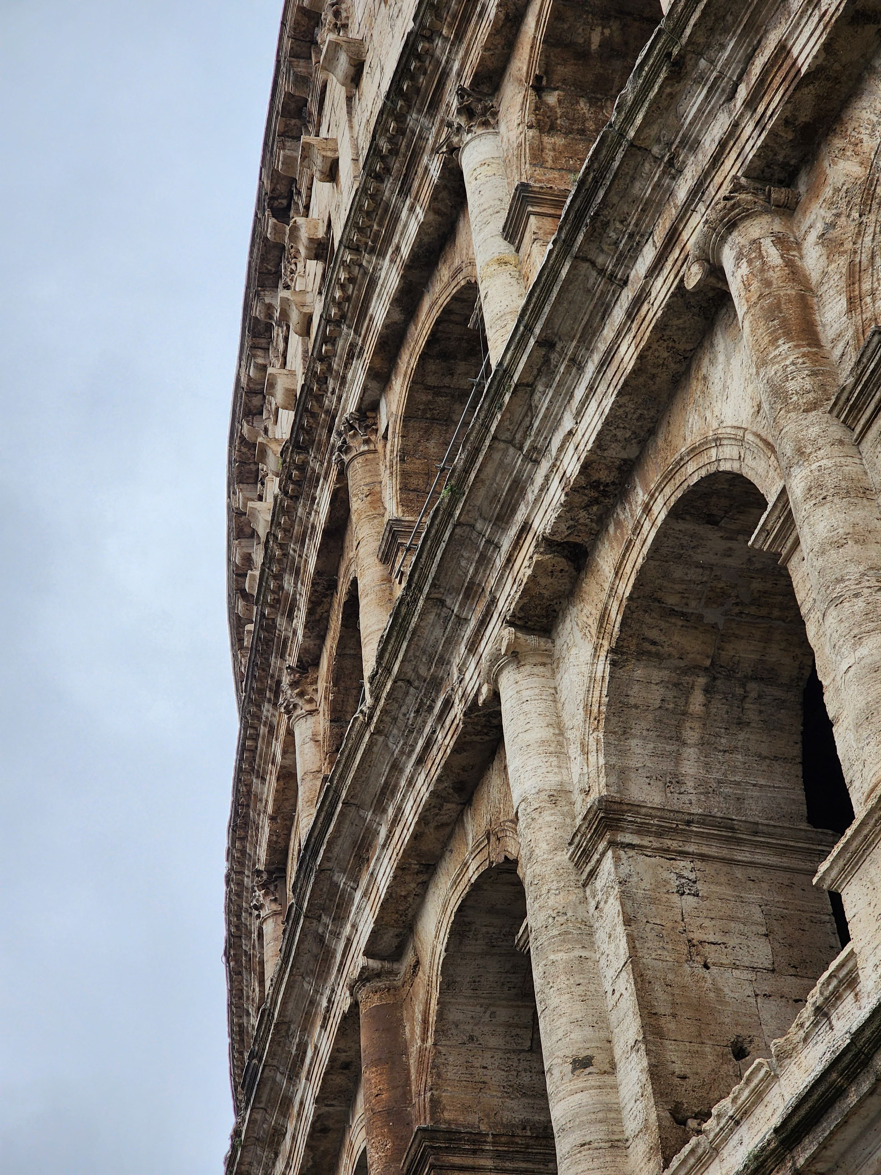 Detailed perspective of the ancient Colosseum's architecture in Rome, Italy.