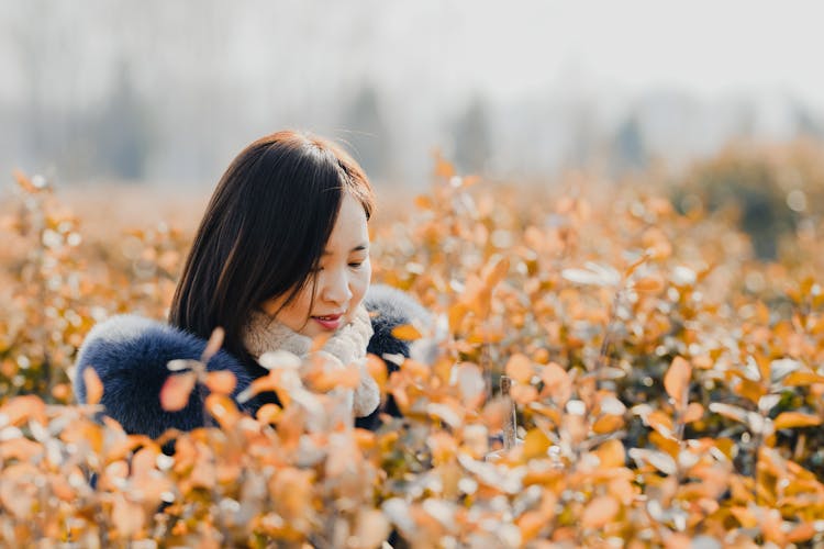 Woman In A Winter Jacket On A Field 