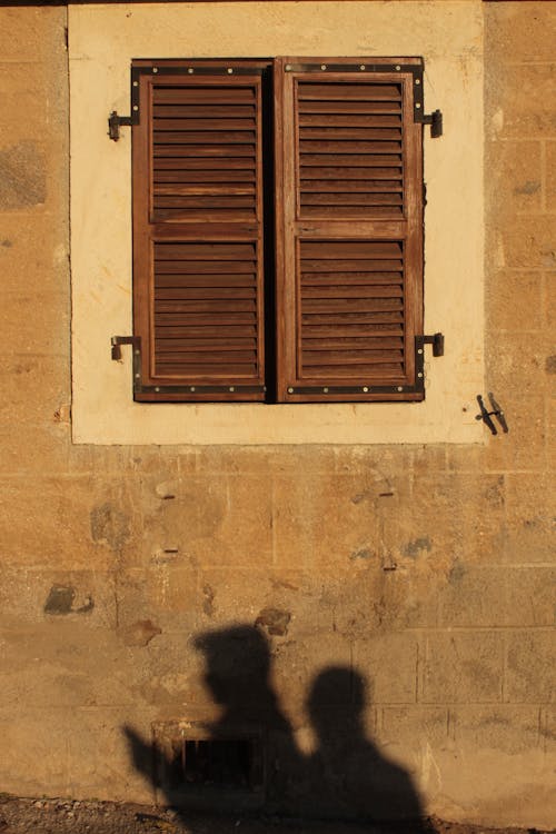 Free Old Rustic Wooden Window on a Concrete Wall Stock Photo