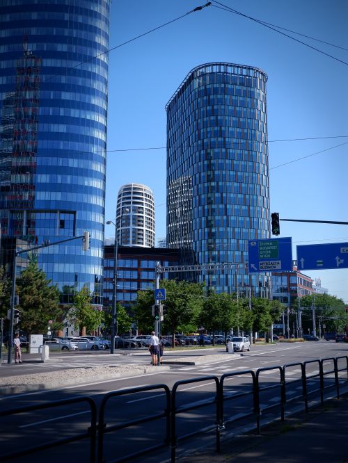 Free View of modern skyscrapers in a vibrant city landscape with clear blue sky. Stock Photo