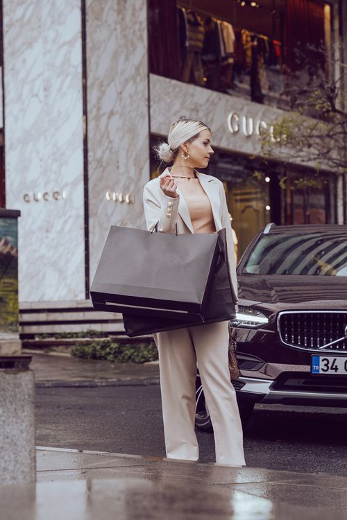 Free Chic woman with shopping bags at Gucci store in İstanbul's luxury district. Stock Photo