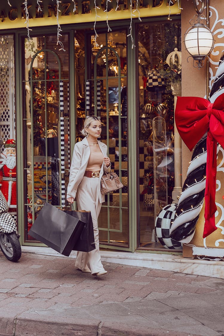 Blonde Woman Walking On A Street With Shopping Bag