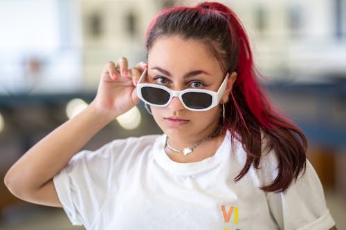 Young Woman with Dyed Hair, Wearing a White T-shirt and Sunglasses