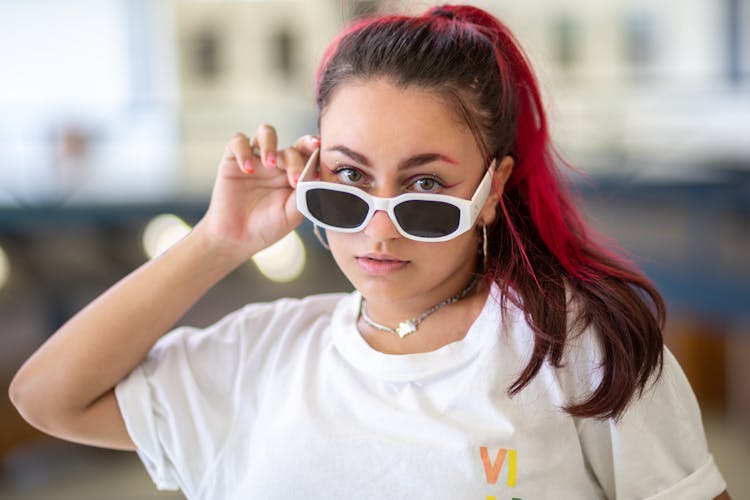 Young Woman With Dyed Hair, Wearing A White T-shirt And Sunglasses