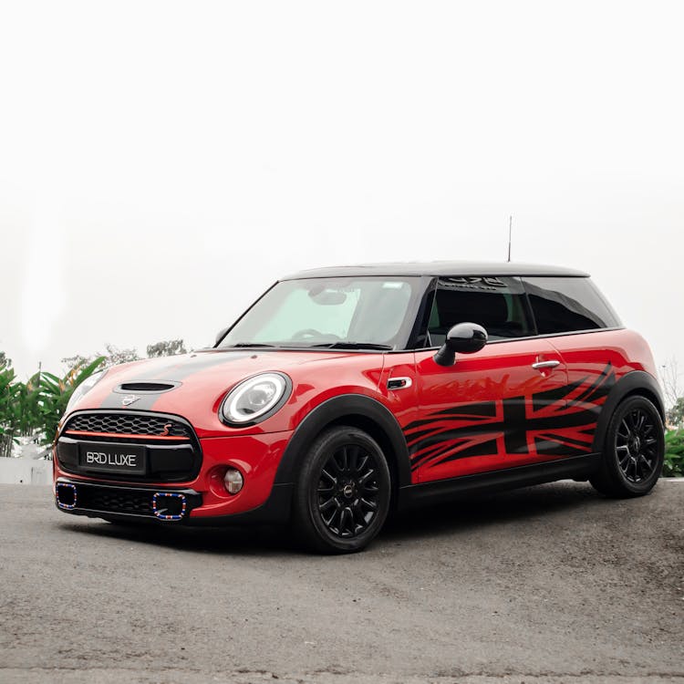 A Red And Black Mini Cooper Parked On The Street