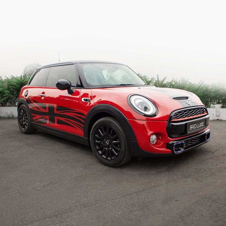 A Red And Black Mini Cooper Parked On The Street