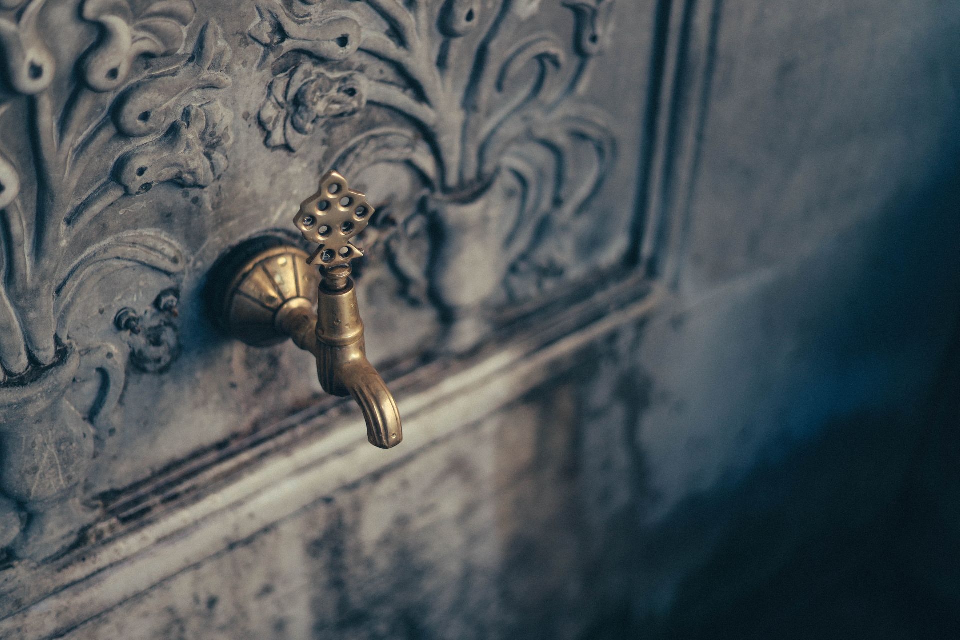 Close-up of a Faucet in a Carved Wall