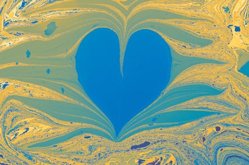 Close-up of a Colorful, Abstract Painting with a Heart Shaped in the Middle 