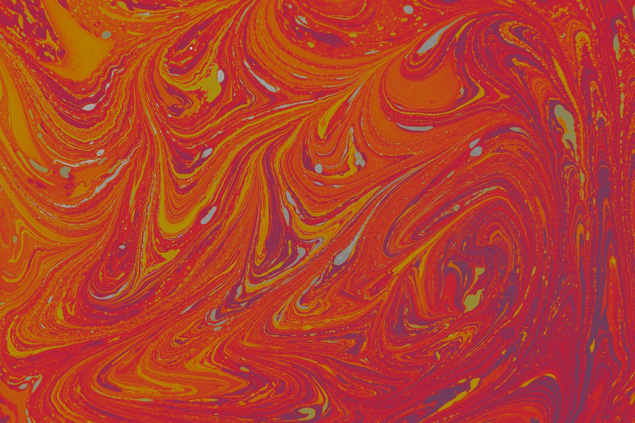 dynamic abstract fluid painting with lively red and orange swirls in a