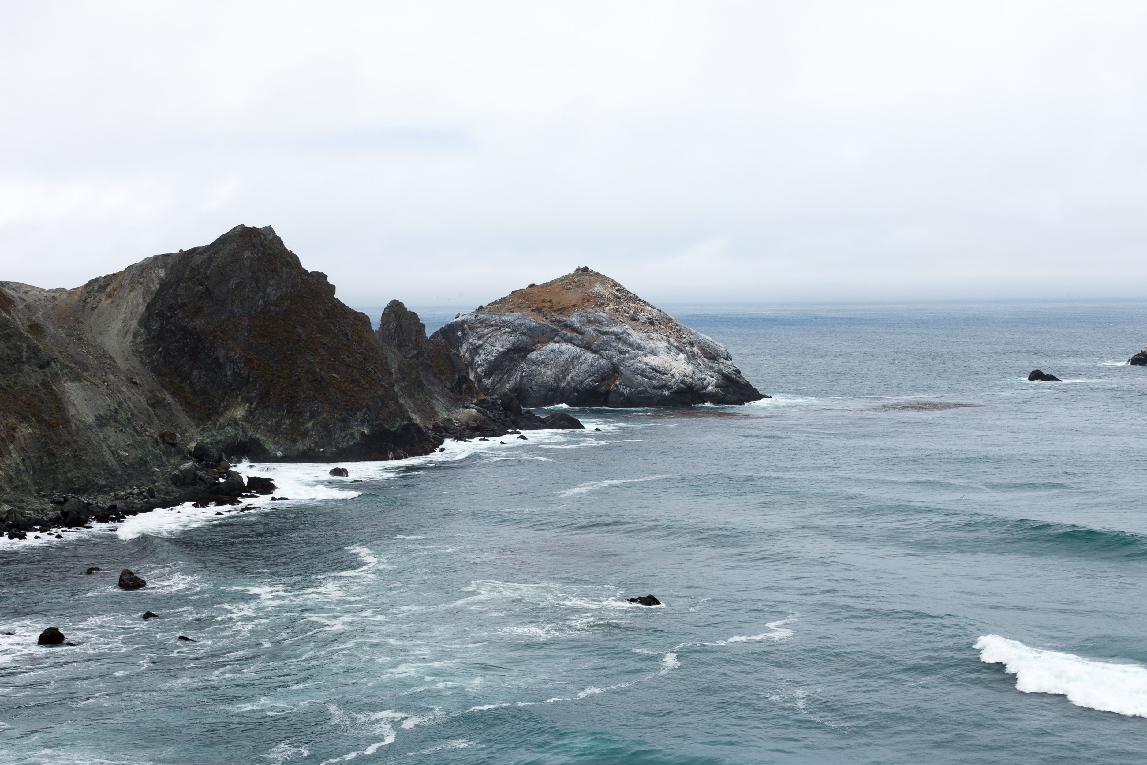 Rocks and Hills around Bay on Sea Shore · Free Stock Photo