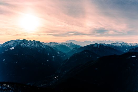 Breathtaking sunrise view of snowcapped mountains in Locarno, Switzerland.