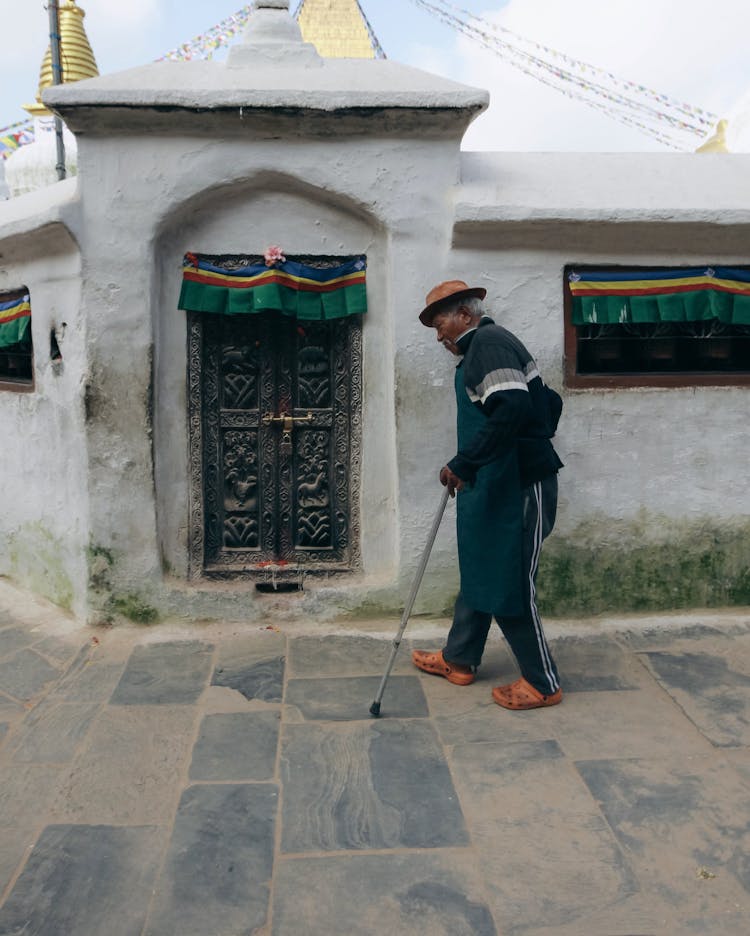 Elderly Man With Cane Walking Old Town Street