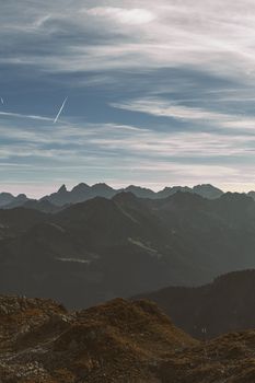 A breathtaking view of a foggy mountain range under a misty evening sky.