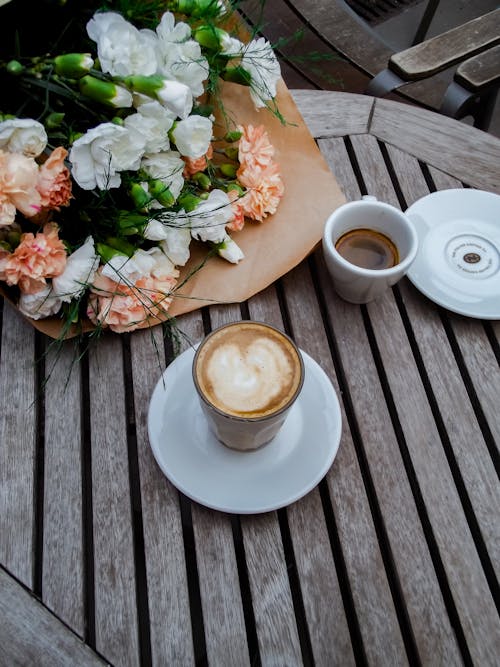 Close-up of Coffee and Bouquet of Flowers