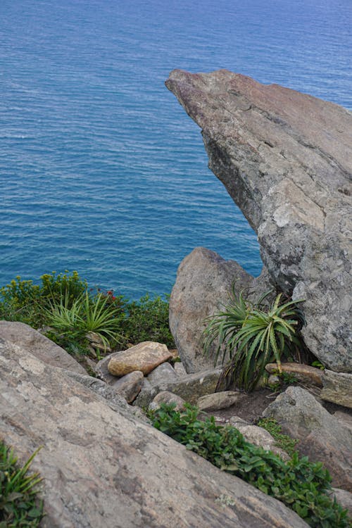 Rocks on Shore of Blue Sea