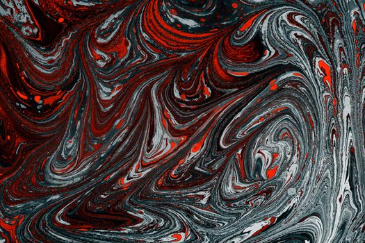 Vivid marbled design in red, black, and white hues creating a dynamic artistic texture.