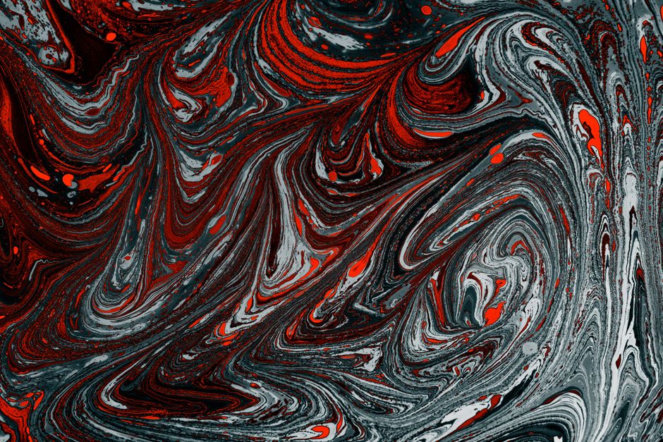 Vivid marbled design in red, black, and white hues creating a dynamic artistic texture.