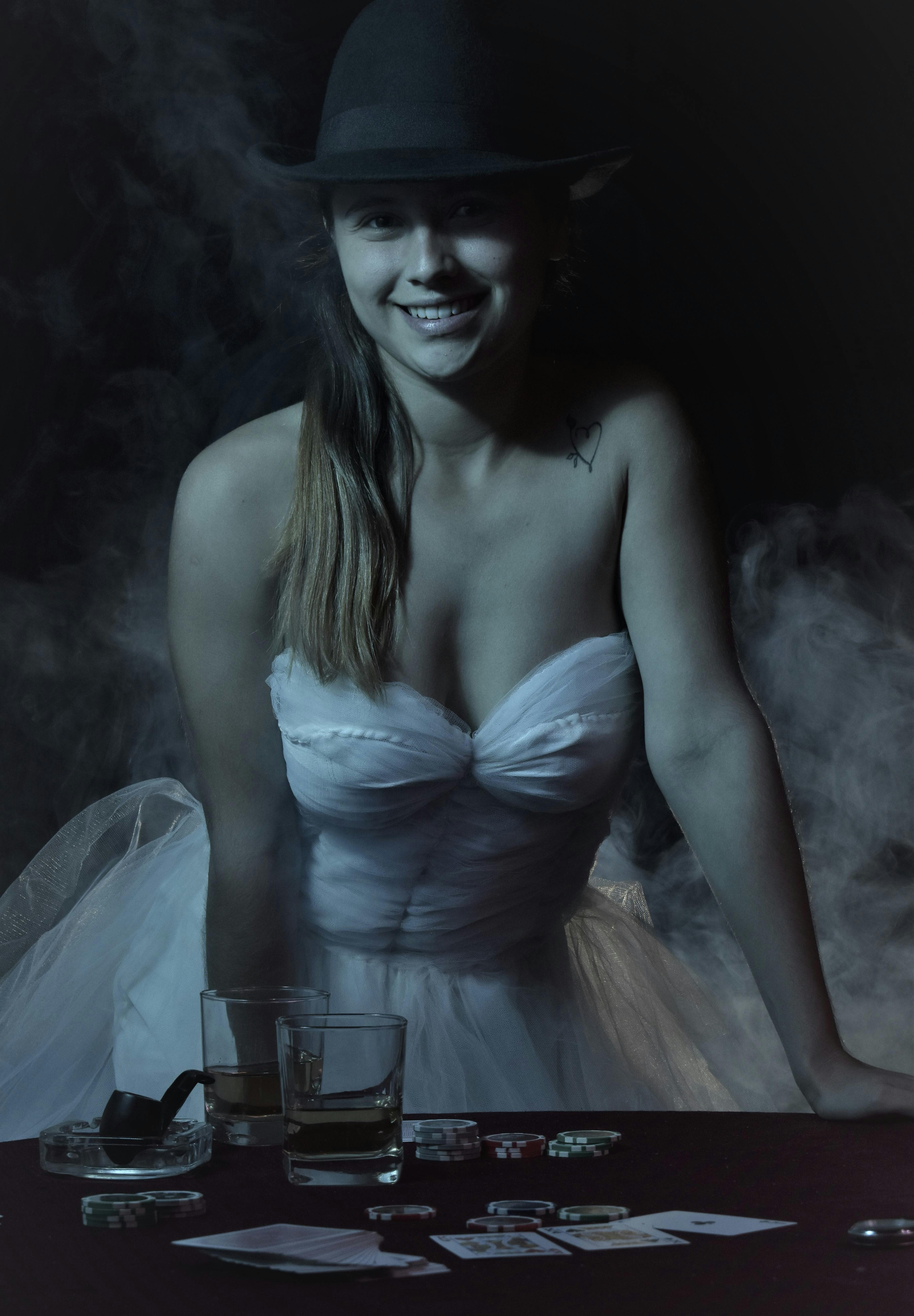 woman in a wedding dress standing behind the table with cards