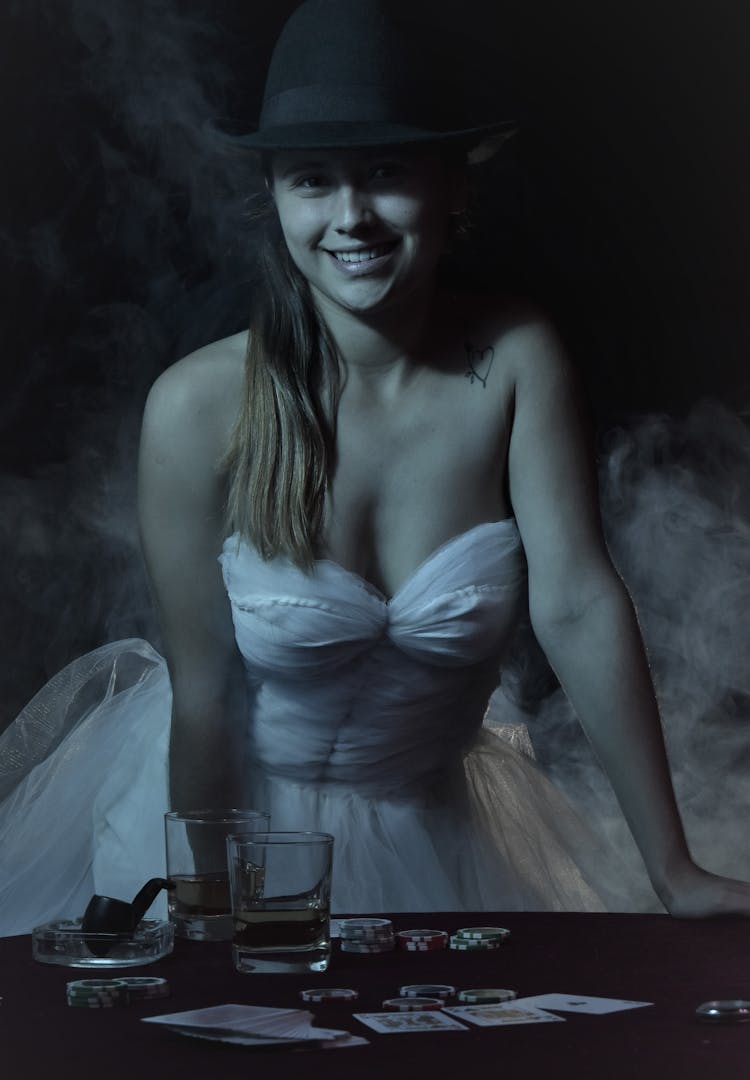 Woman In A Wedding Dress Standing Behind The Table With Cards