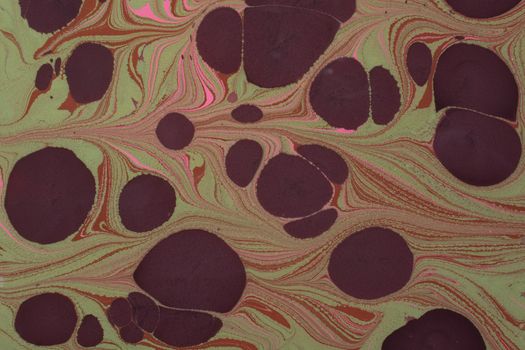 Colorful abstract marbled pattern with earthy tones and circular shapes for creative backgrounds.