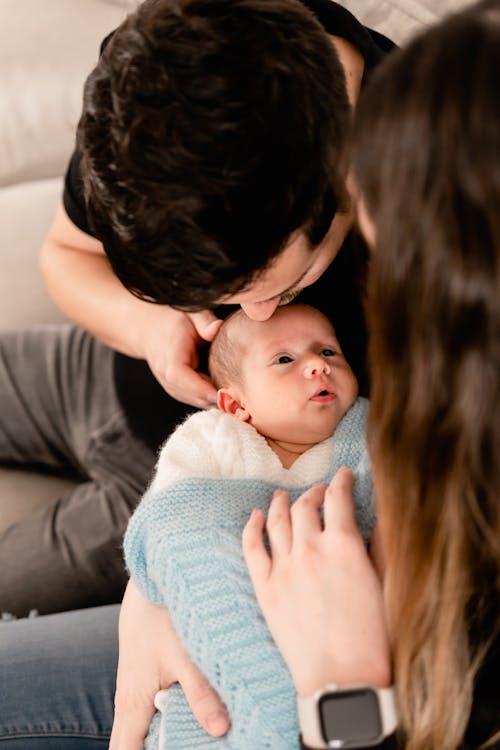 Father and Mother Holding Baby