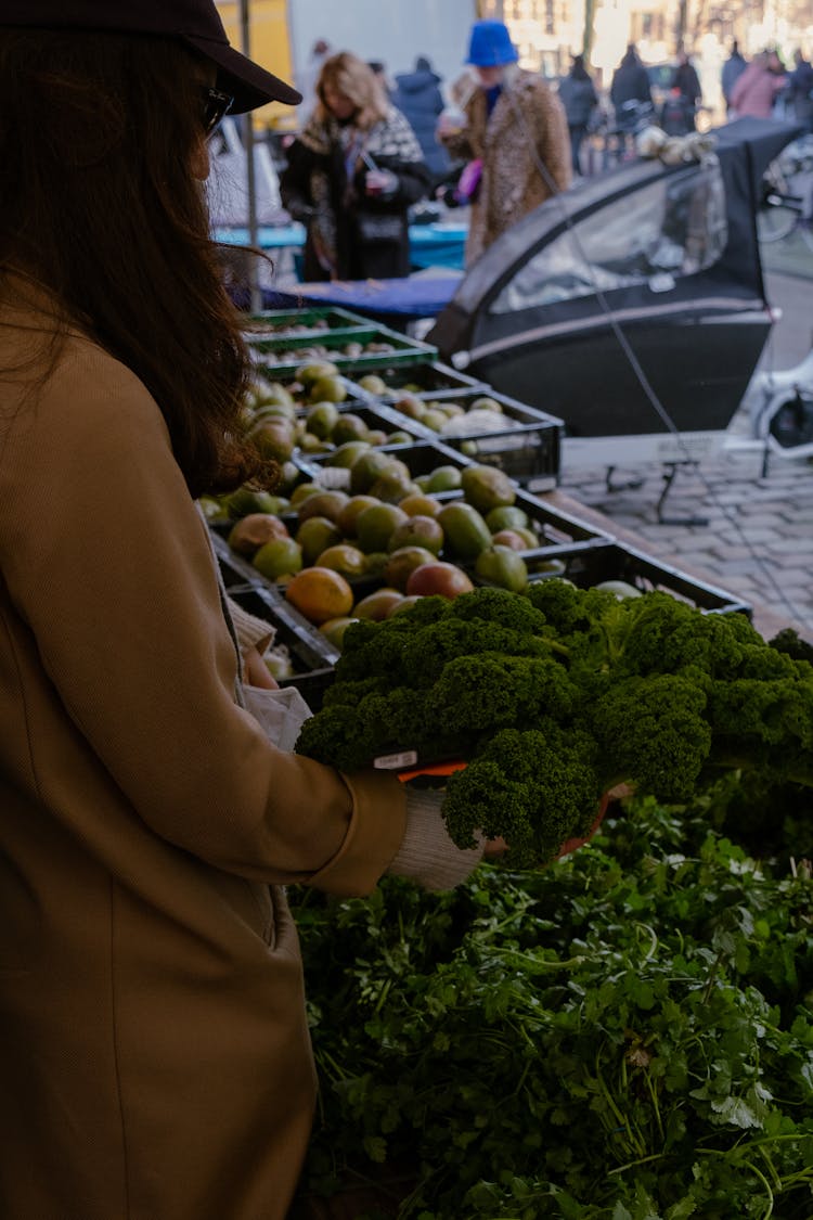 Woman On Bazaar With Vegetables