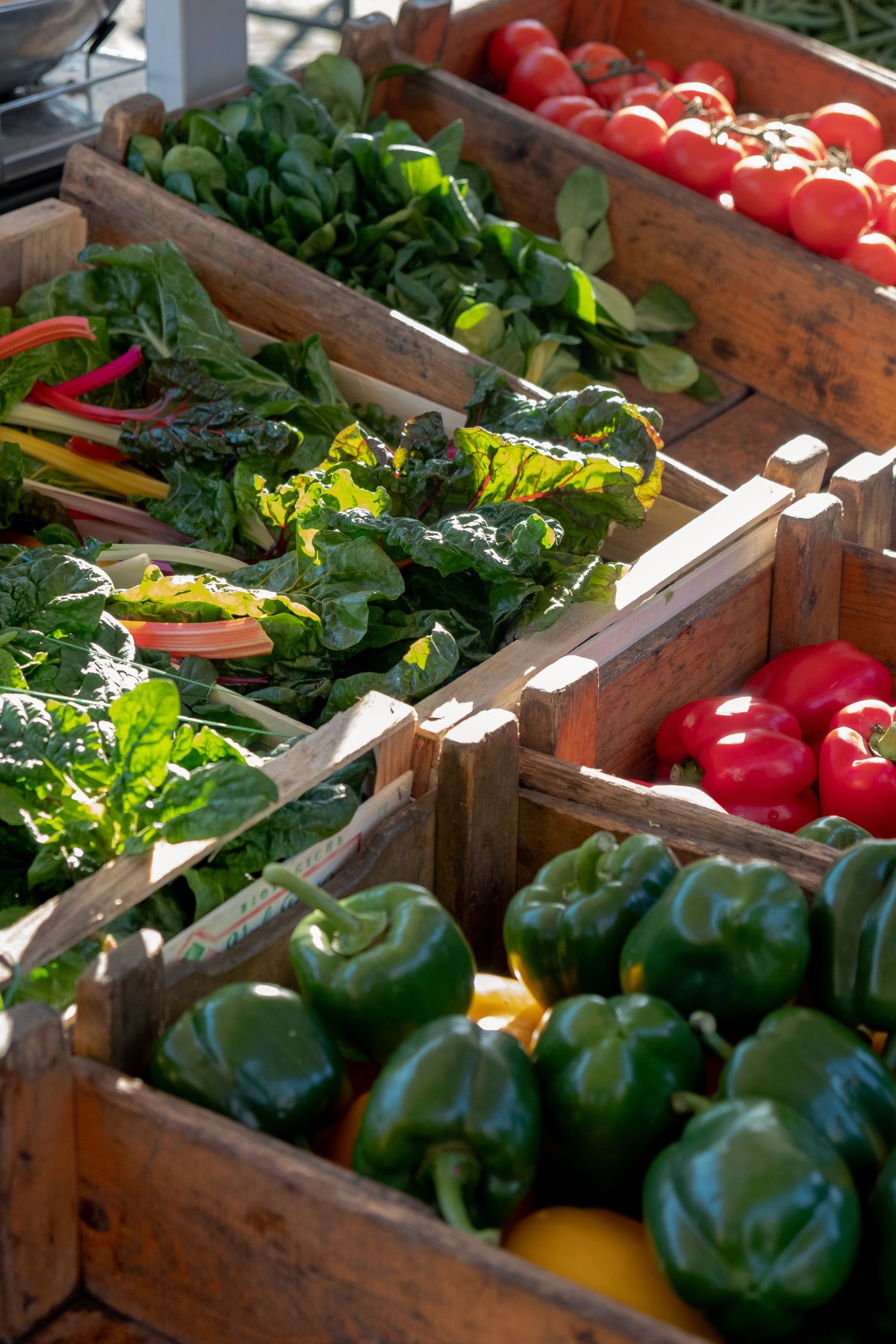 Colourful peppers, tomatoes and fresh vegetables at a produce market