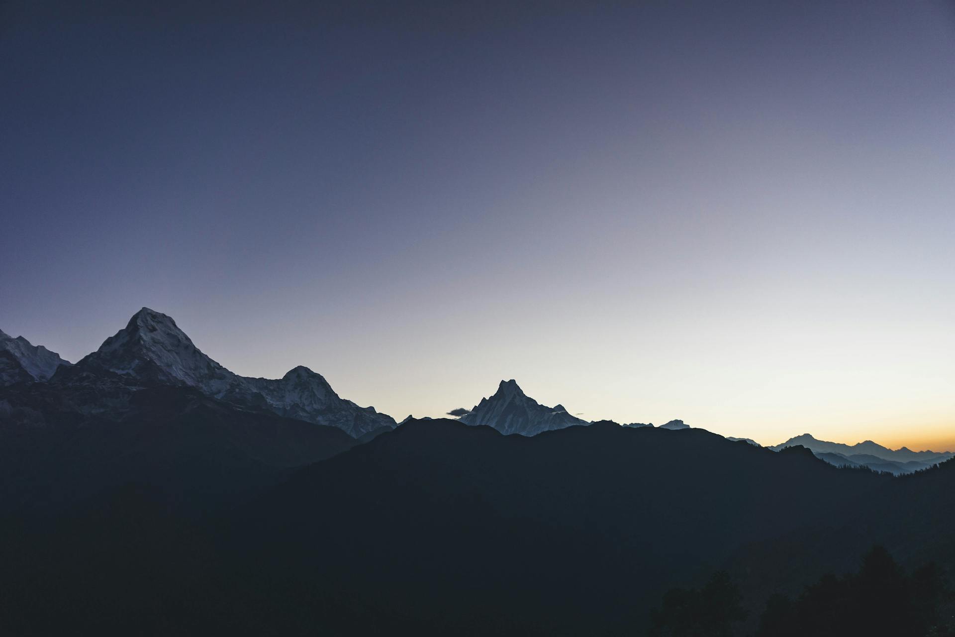 Dramatic sunset view of the Annapurna Range in Nepal showcasing majestic peaks and serene skies.