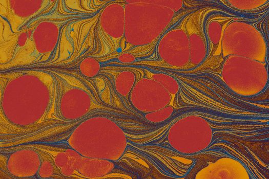 Colorful abstract marbled pattern featuring vibrant red and yellow hues with swirling shapes.