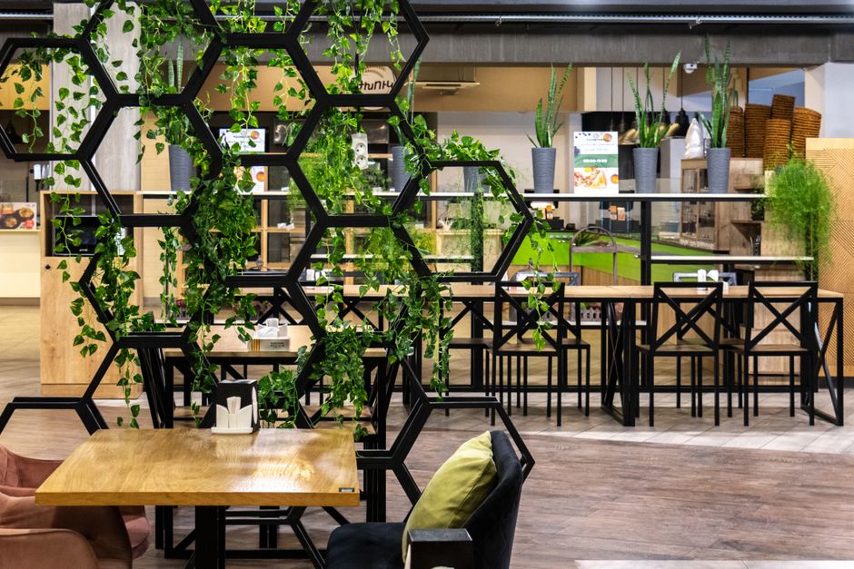 Stylish food court in Yerevan with modern design and greenery accents.