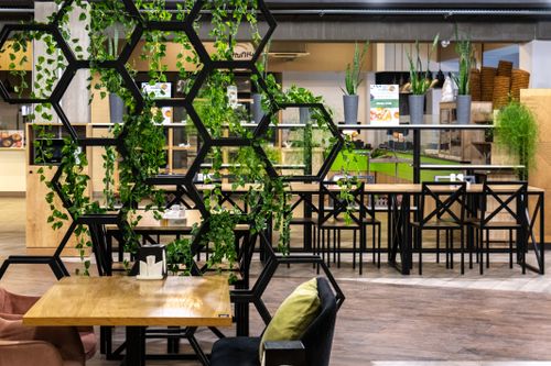 Free Stylish food court in Yerevan with modern design and greenery accents. Stock Photo