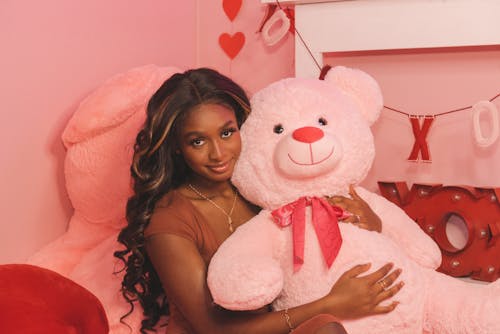 Woman Embracing Pink Soft Toy