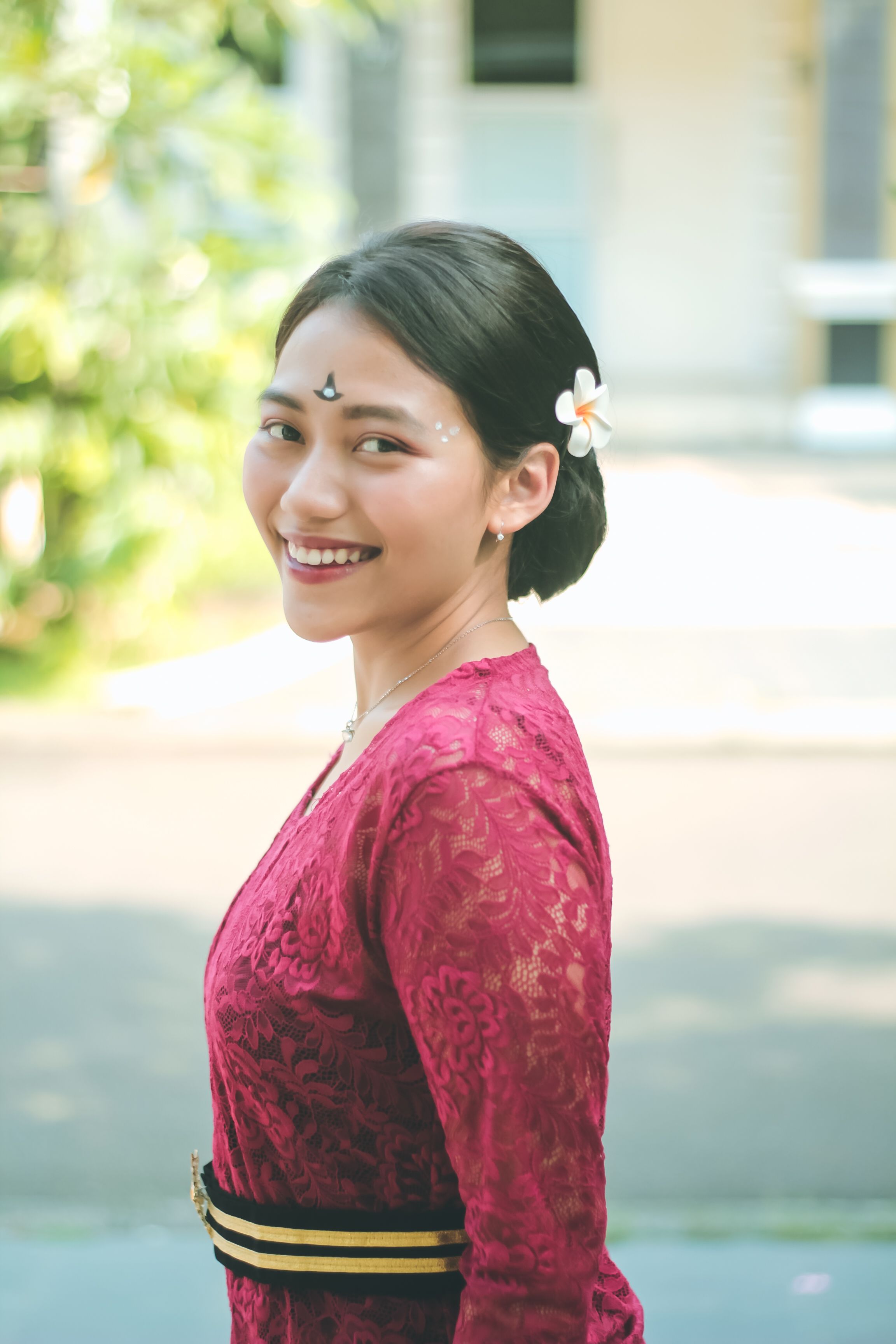 Smiling Woman in Red Dress with Flower in Hair · Free Stock Photo
