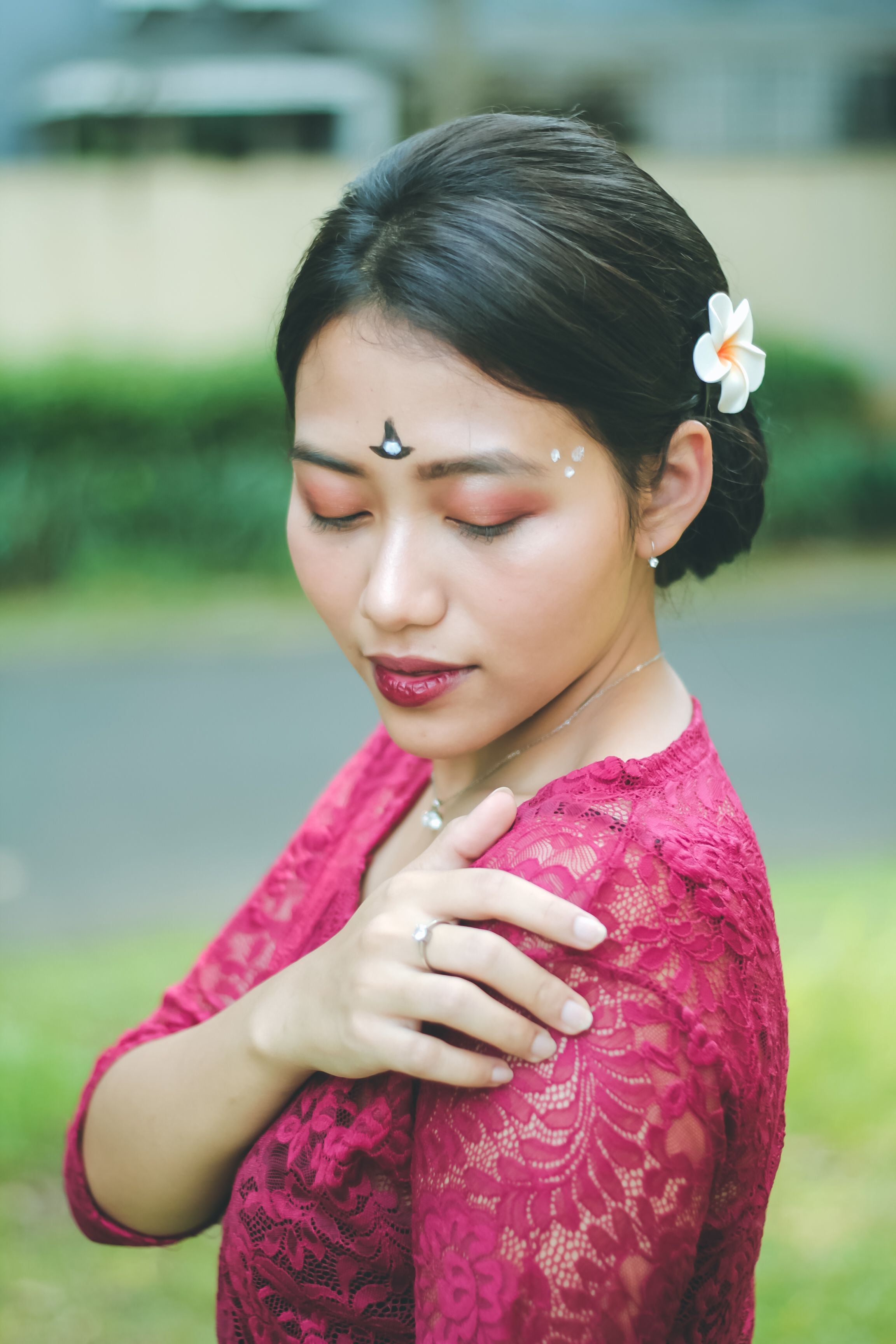 Woman in Red Dress with Bindi Holding Hand on Shoulder · Free Stock Photo