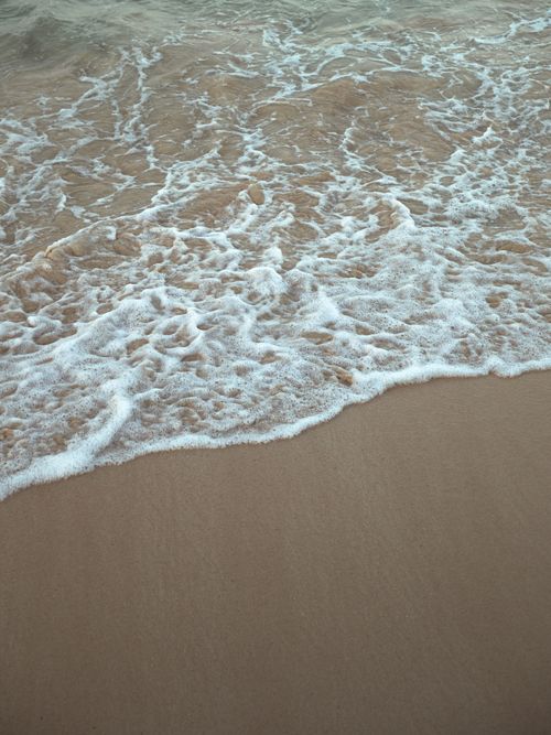 Free Gentle waves lapping the sandy shore in Punta Cana, Dominican Republic. Stock Photo