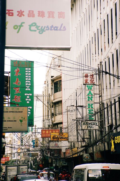 Free Dynamic view of an urban street filled with diverse signs and bustling activity. Stock Photo