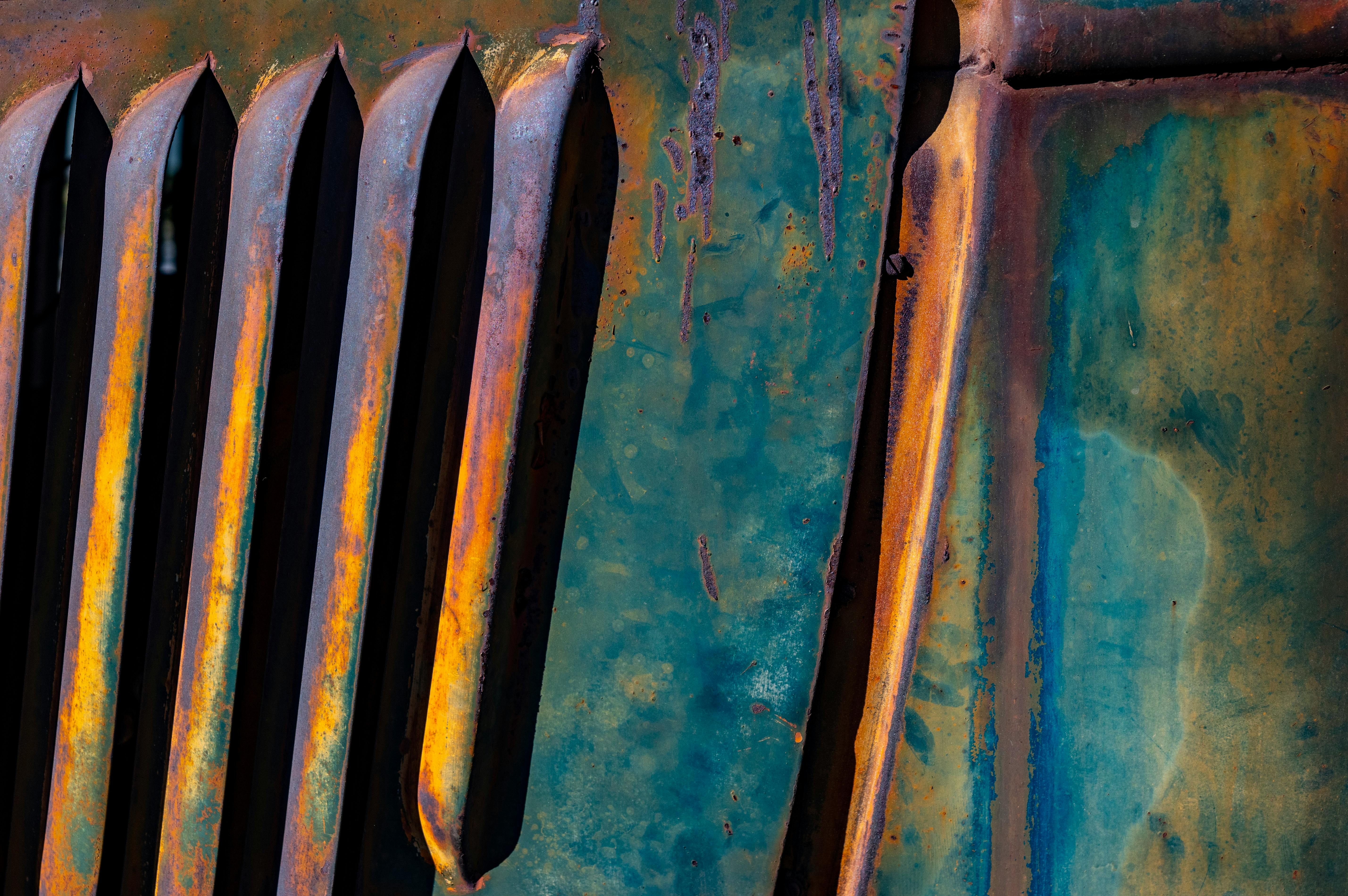 Close-up of rusted metal with vibrant patina, showcasing unique texture and color.