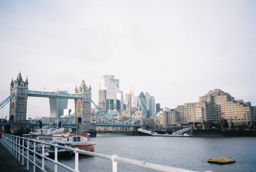 A view of Tower Bridge and the modern architecture of London's skyline across the river.