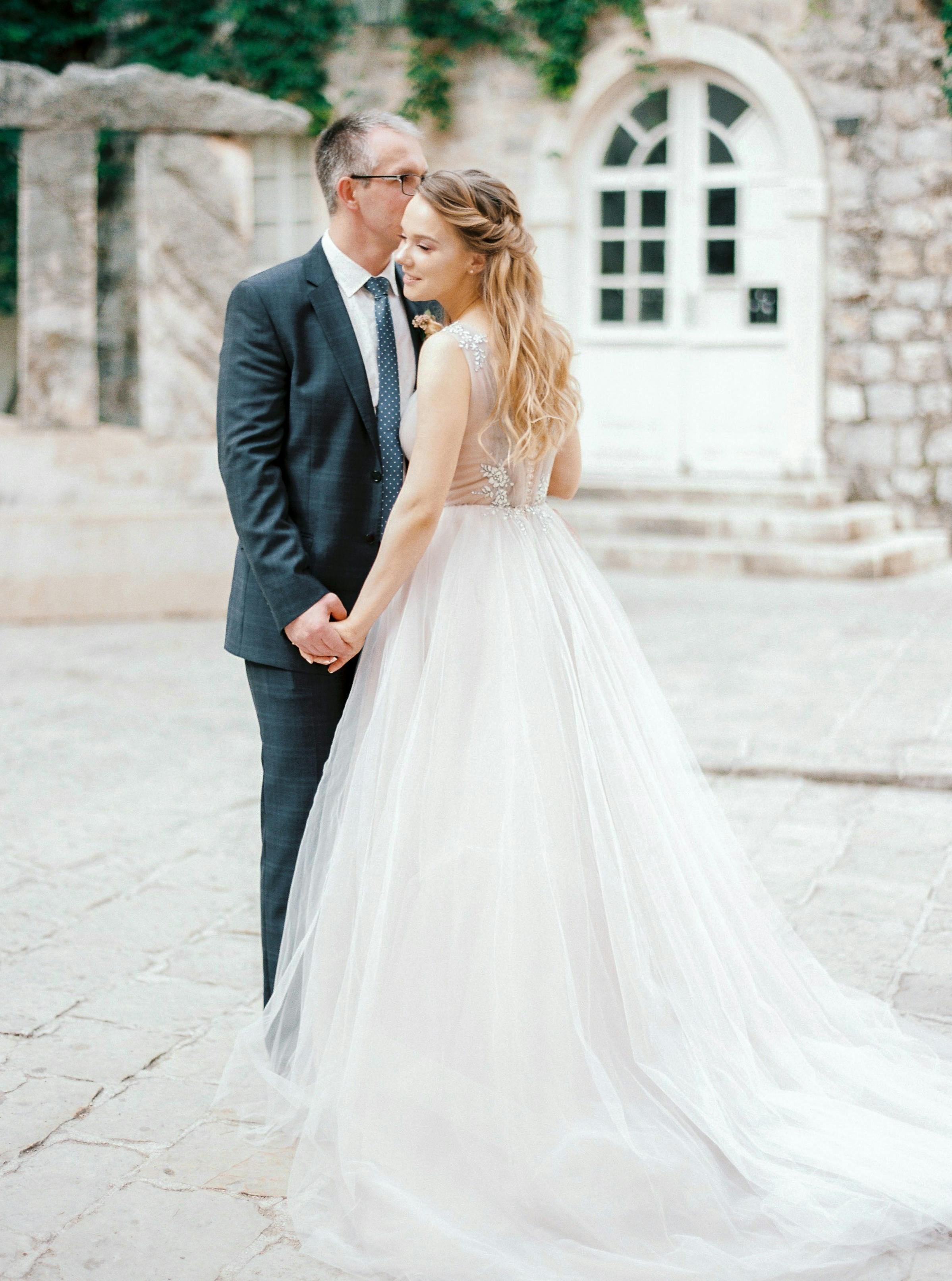 young bride and groom holding hands