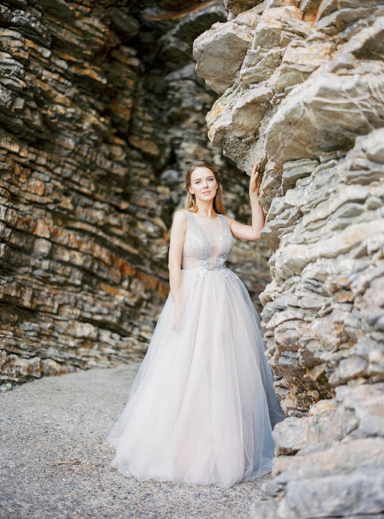 Bride In Wedding Dress Posing Near Cliff