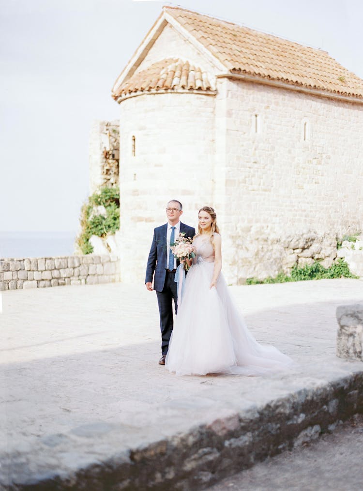 Bride And Groom Posing Near Old Castle