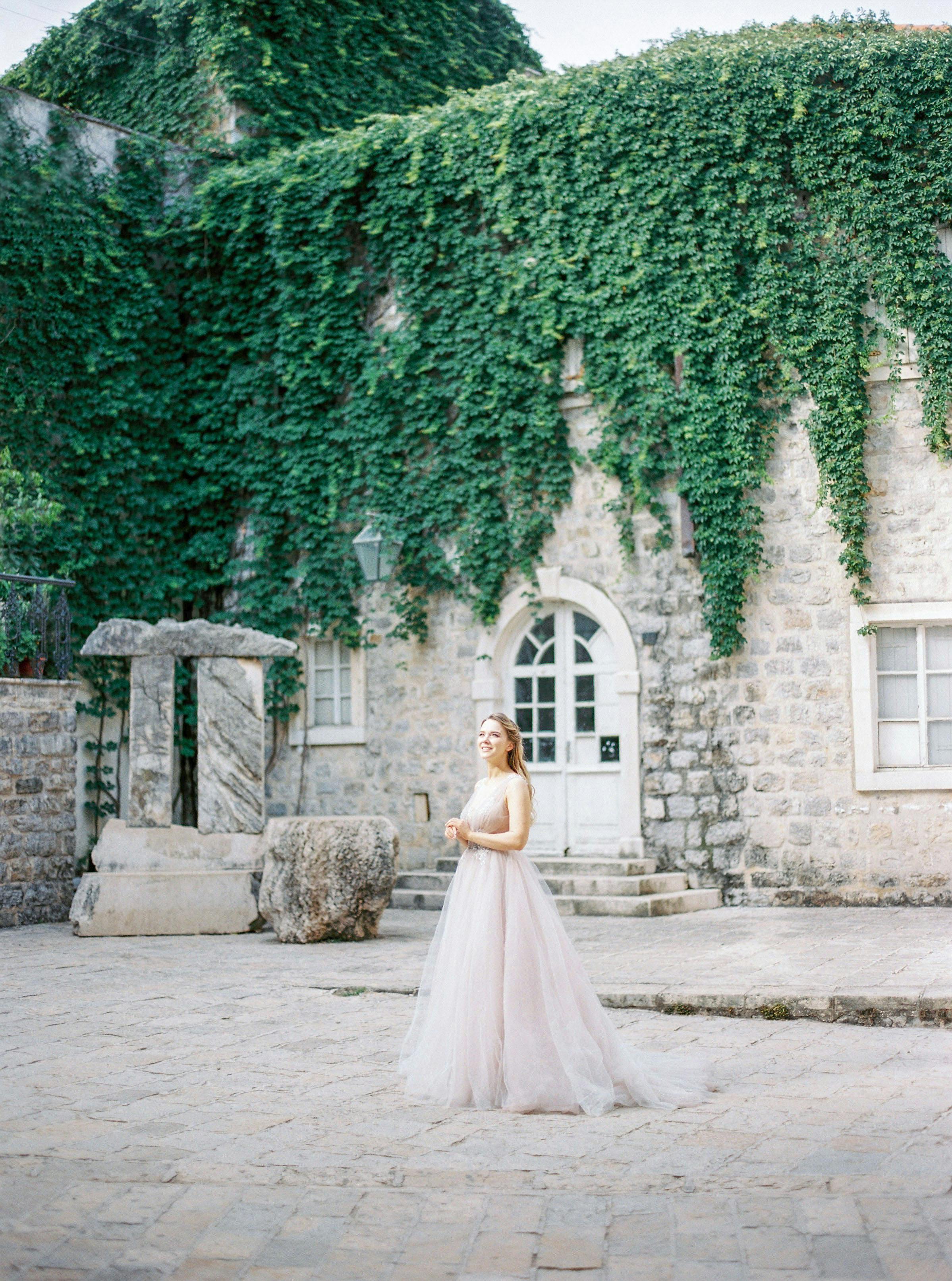 bride in wedding dress posing near old castle